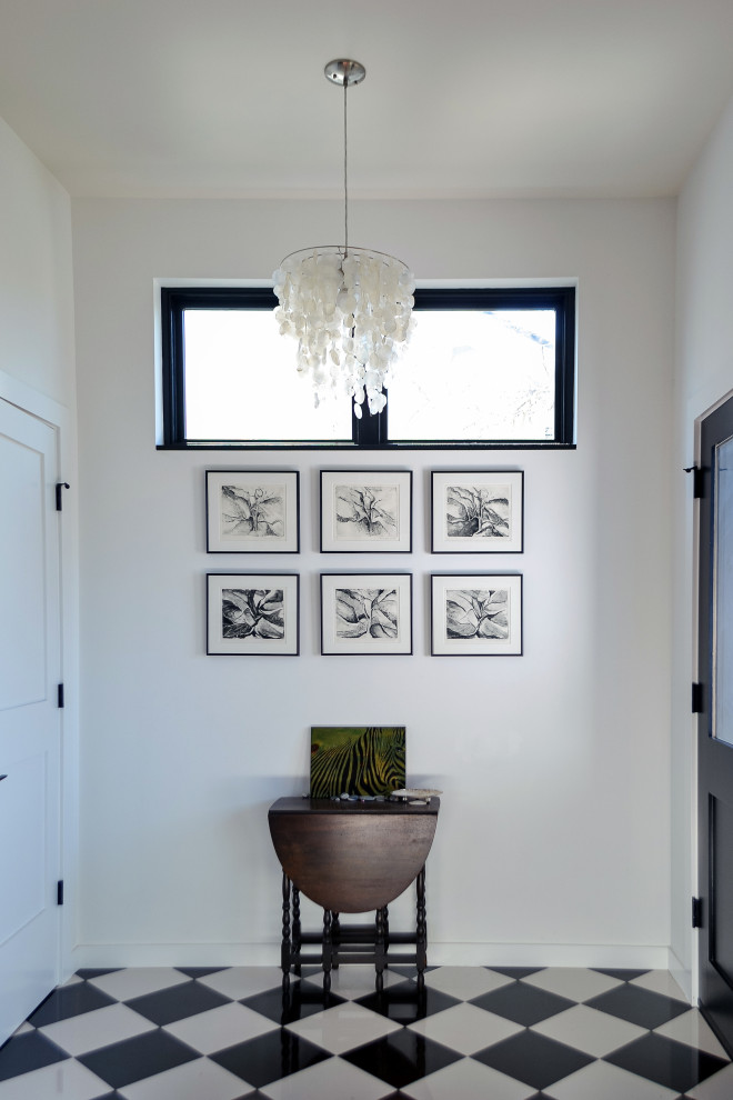 Small transitional porcelain tile and black floor entry hall photo in Seattle with white walls and a dark wood front door