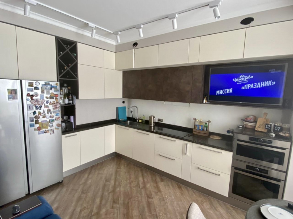 Large contemporary l-shaped eat-in kitchen in Moscow with an undermount sink, flat-panel cabinets, white cabinets, solid surface benchtops, white splashback, stainless steel appliances, porcelain floors, no island, multi-coloured floor, brown benchtop and recessed.