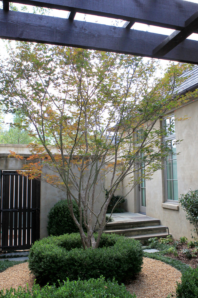 This is an example of a mid-sized transitional partial sun backyard stone formal garden in Birmingham.