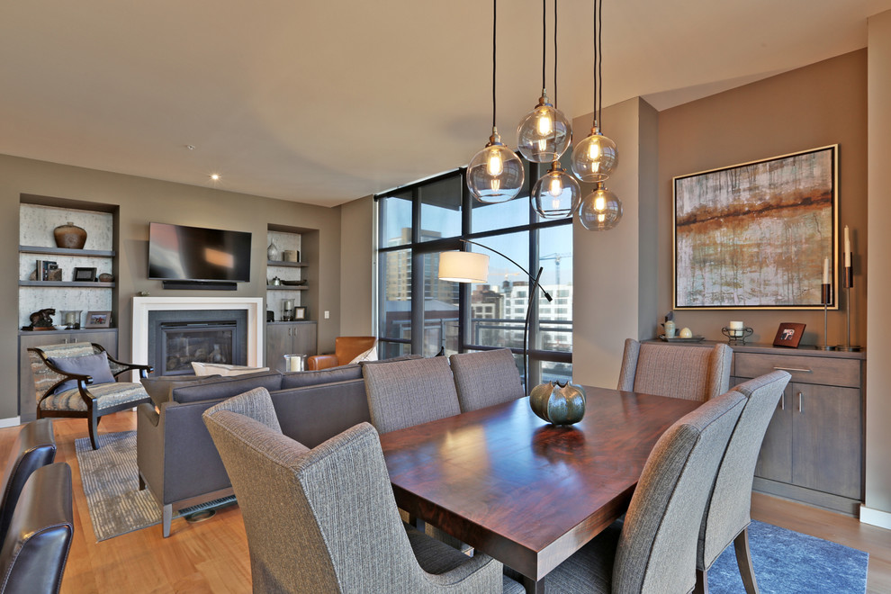 Design ideas for a small contemporary open plan dining in Portland with grey walls and light hardwood floors.