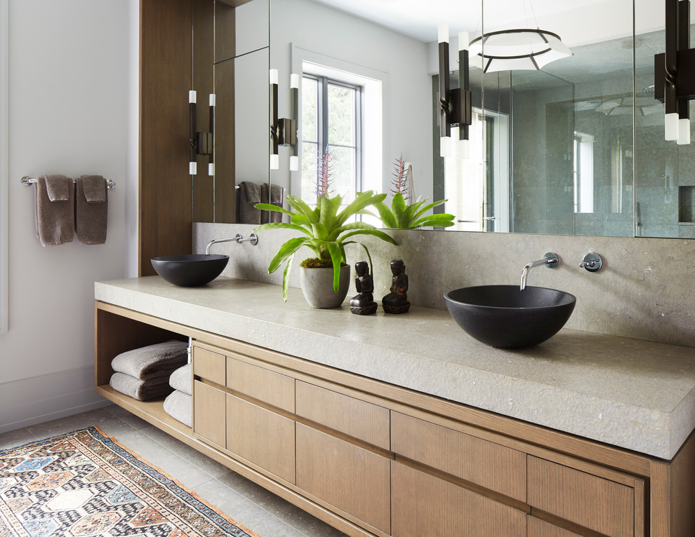 Photo of a contemporary bathroom in Chicago with flat-panel cabinets, medium wood cabinets, white walls, a vessel sink, grey floor and beige benchtops.