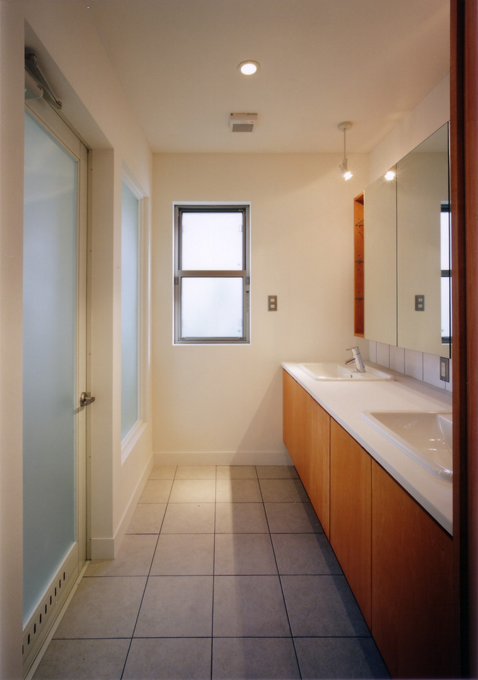 This is an example of a modern powder room in Other with flat-panel cabinets, medium wood cabinets, white walls and grey floor.