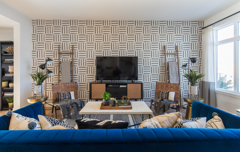 Inspiration for a large contemporary open concept medium tone wood floor and brown floor living room remodel in Calgary with a tv stand and multicolored walls