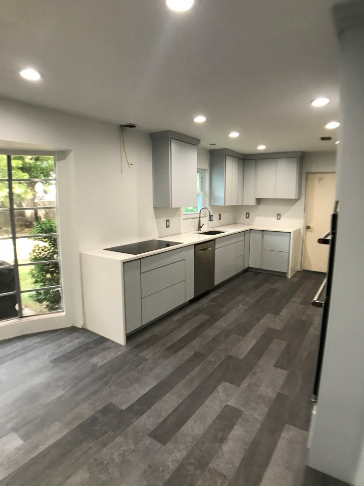 Large transitional galley laminate floor and multicolored floor eat-in kitchen photo in Dallas with an undermount sink, flat-panel cabinets, gray cabinets, quartzite countertops, stainless steel appliances, no island and white countertops