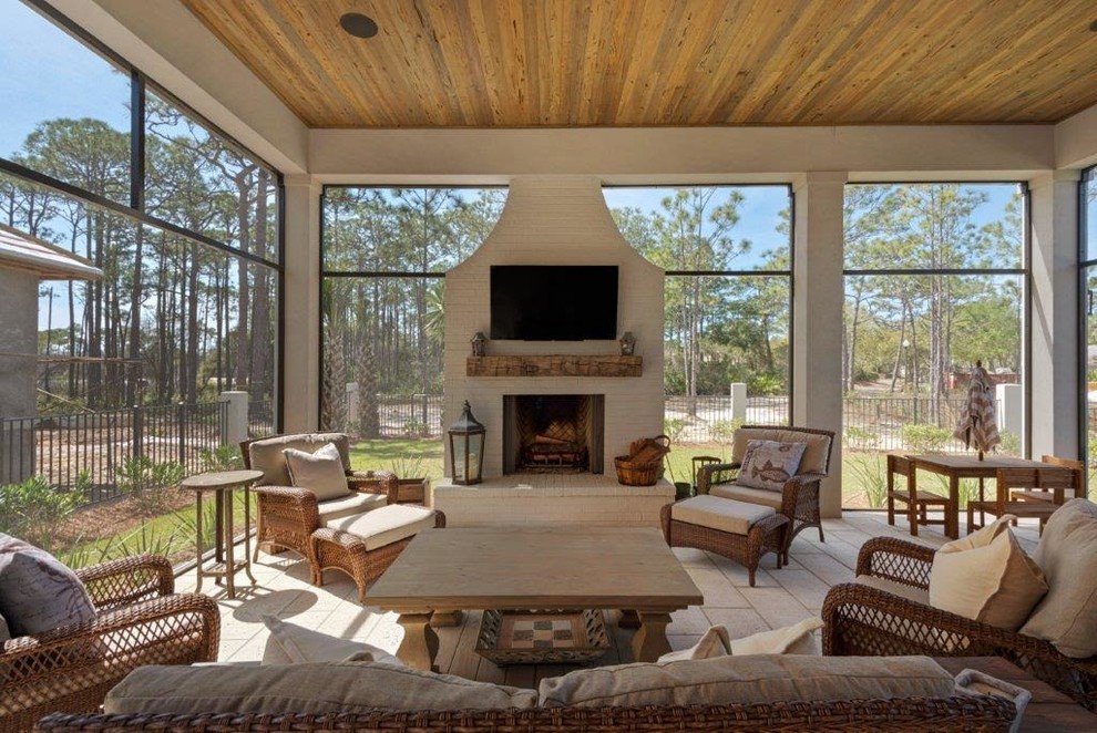 Inspiration for an expansive country sunroom in Miami with limestone floors, a standard fireplace, a brick fireplace surround, a standard ceiling and beige floor.