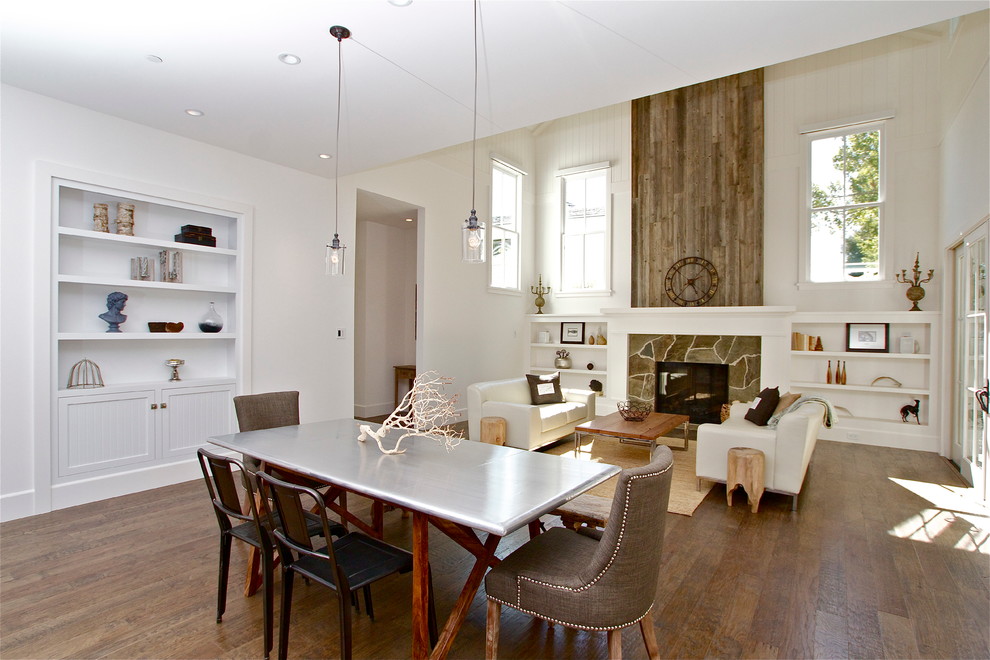 This is an example of a country dining room in San Francisco with white walls and dark hardwood floors.