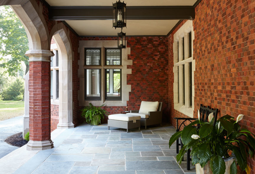 Mid-sized transitional front yard verandah in Philadelphia with tile and a roof extension.