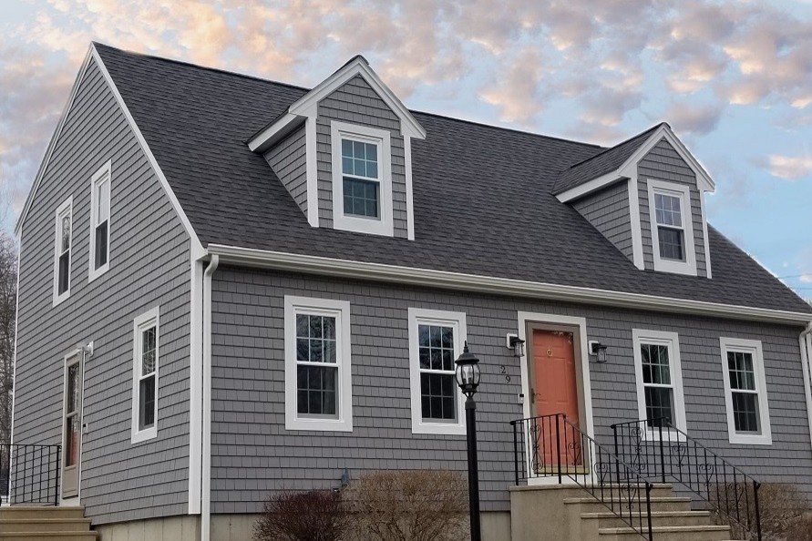 Photo of a mid-sized traditional two-storey grey house exterior in Providence with vinyl siding, a gable roof and a shingle roof.