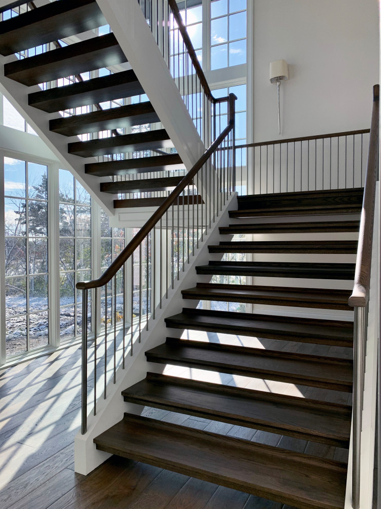 This is an example of a contemporary wood floating wood railing staircase in Chicago.