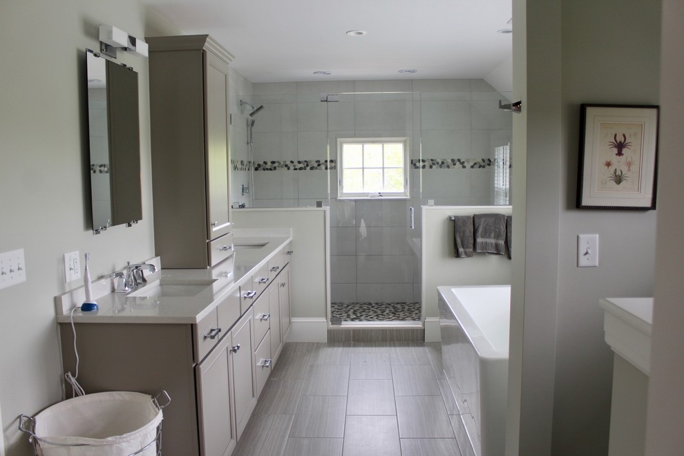 Design ideas for a large transitional 3/4 bathroom in Boston with raised-panel cabinets, brown cabinets, an alcove tub, an alcove shower, a one-piece toilet, gray tile, mosaic tile, grey walls, ceramic floors, an undermount sink, soapstone benchtops, grey floor and a hinged shower door.