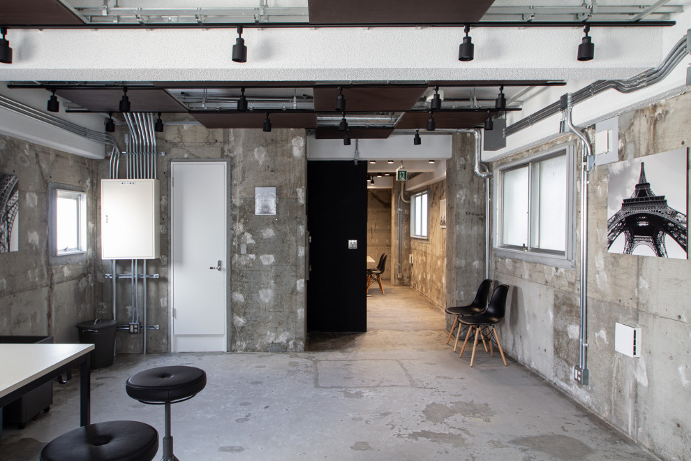 Réalisation d'un bureau urbain de taille moyenne et de type studio avec un mur gris, sol en béton ciré, aucune cheminée, un bureau indépendant, un sol gris et un plafond à caissons.