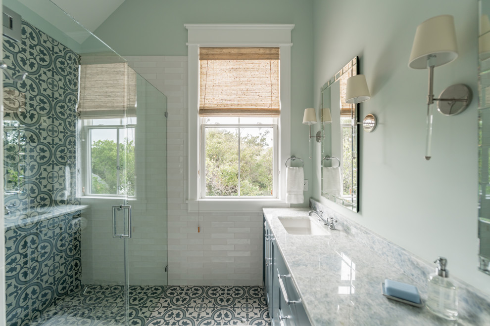 This is an example of a beach style master bathroom in Other with shaker cabinets, blue cabinets, a curbless shower, blue tile, green walls, a drop-in sink, a hinged shower door, blue benchtops, a double vanity, a built-in vanity and vaulted.