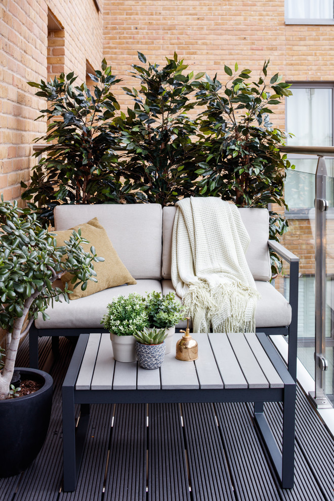Inspiration for a medium sized contemporary glass railing balcony in London with a potted garden.