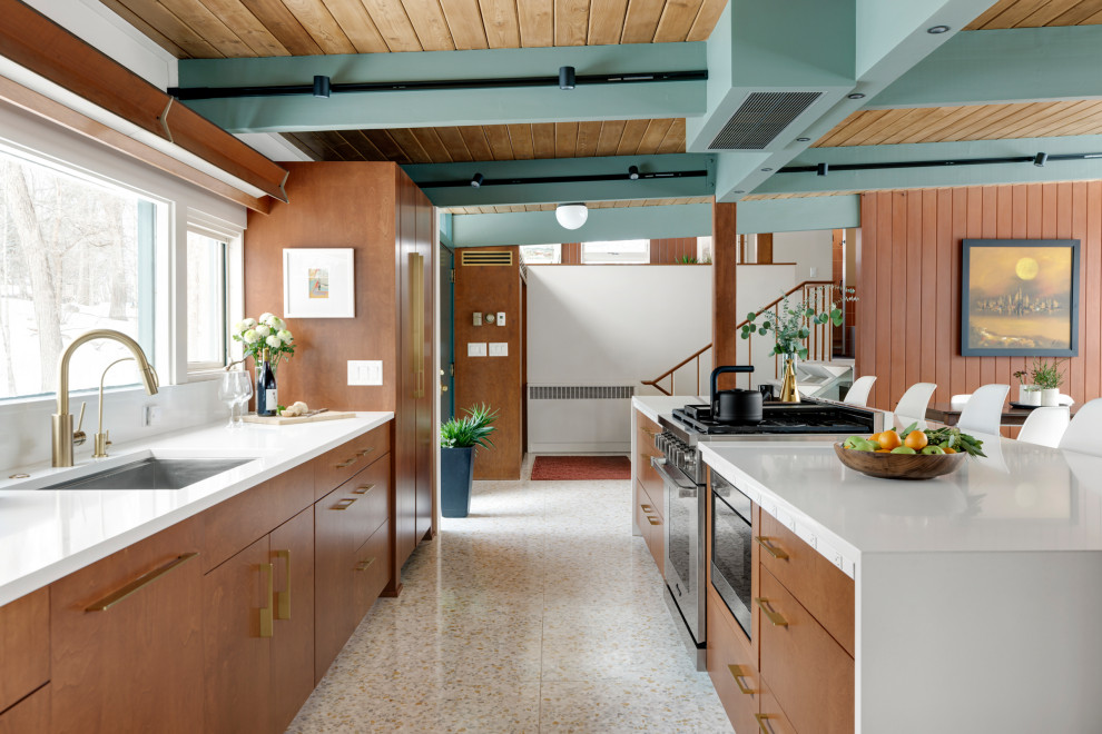 Inspiration for a mid-sized 1950s terrazzo floor, white floor and exposed beam eat-in kitchen remodel in Minneapolis with an undermount sink, flat-panel cabinets, brown cabinets, quartz countertops, white backsplash, quartz backsplash, paneled appliances, an island and white countertops