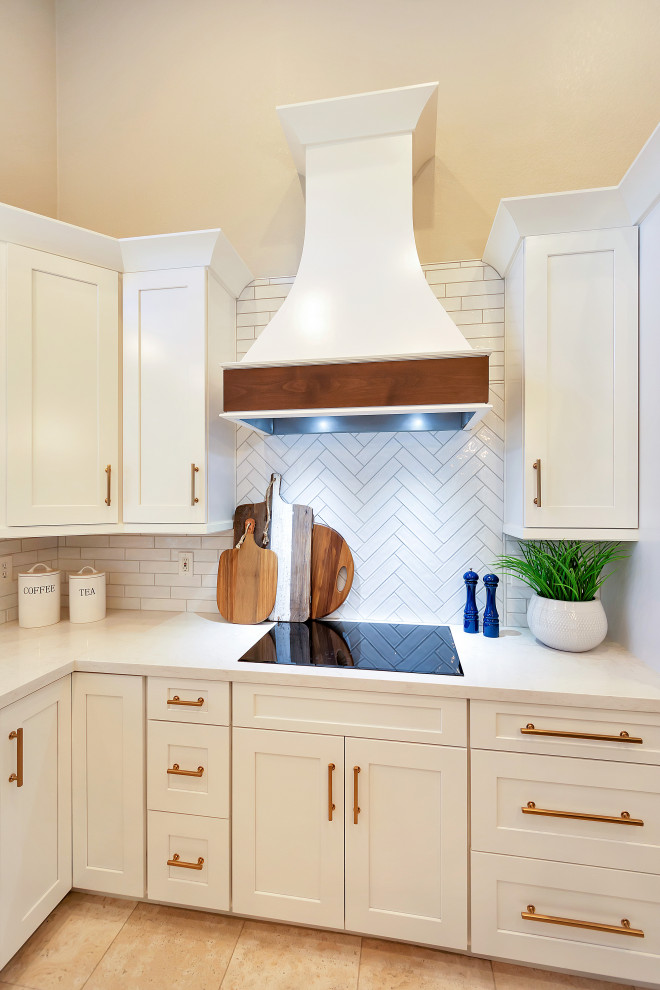 Inspiration for a large transitional u-shaped open concept kitchen remodel in Phoenix with a farmhouse sink, shaker cabinets, white cabinets, quartz countertops, white backsplash, subway tile backsplash, stainless steel appliances, an island and white countertops