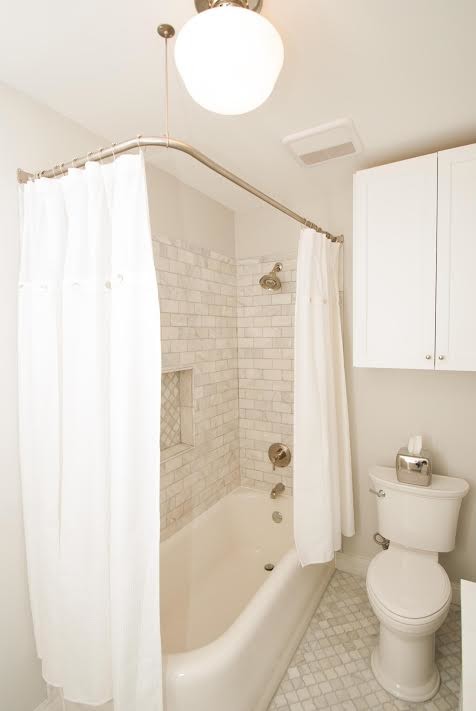 Inspiration for a small transitional gray tile, white tile and subway tile mosaic tile floor alcove bathtub remodel with recessed-panel cabinets, white cabinets, a two-piece toilet, white walls and an undermount sink