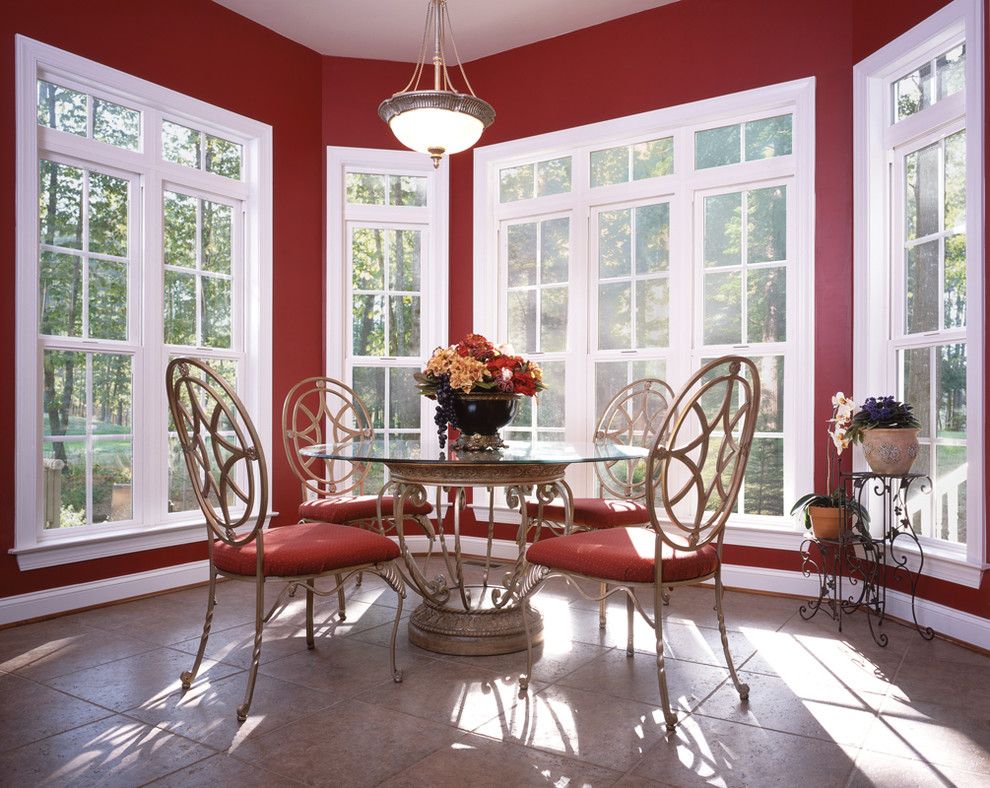 Mid-sized traditional separate dining room in Denver with red walls, travertine floors, no fireplace and grey floor.