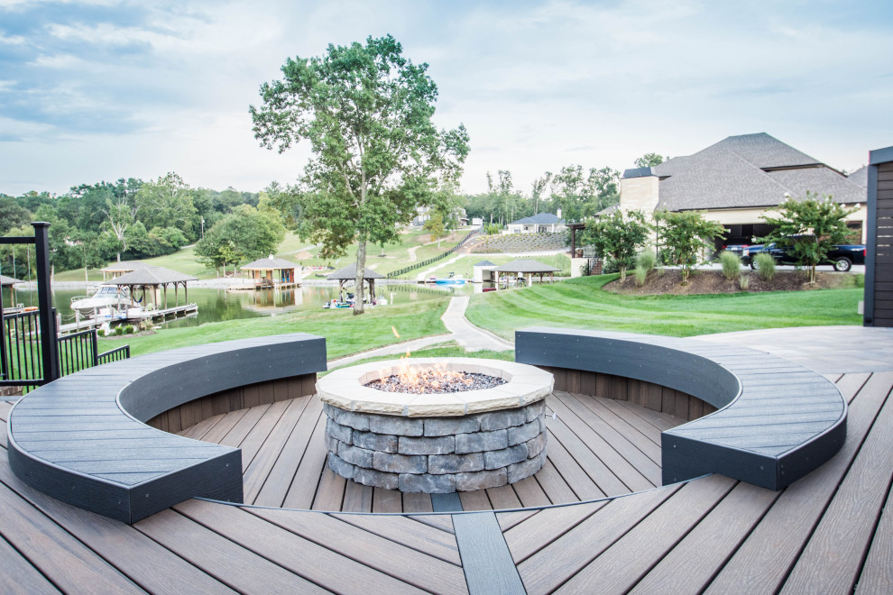 Example of a large transitional backyard deck design with a fire pit and no cover