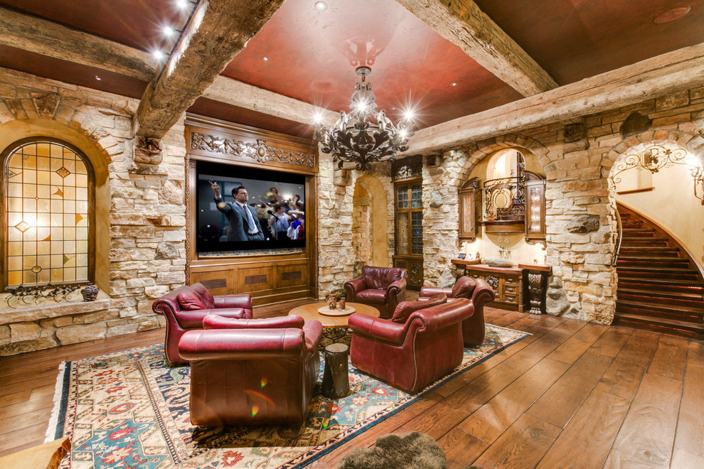 This is an example of a traditional family room in Minneapolis with medium hardwood floors and a built-in media wall.