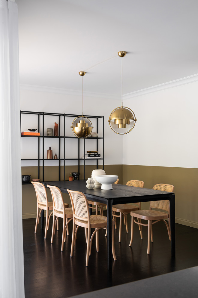 Mid-sized contemporary open plan dining in Melbourne with white walls, dark hardwood floors and black floor.