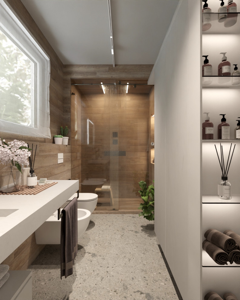 This is an example of a mid-sized contemporary 3/4 bathroom in Other with beaded inset cabinets, grey cabinets, an alcove shower, a wall-mount toilet, brown tile, wood-look tile, porcelain floors, a trough sink, solid surface benchtops, grey floor, a sliding shower screen, grey benchtops, a single vanity, a floating vanity and wood walls.