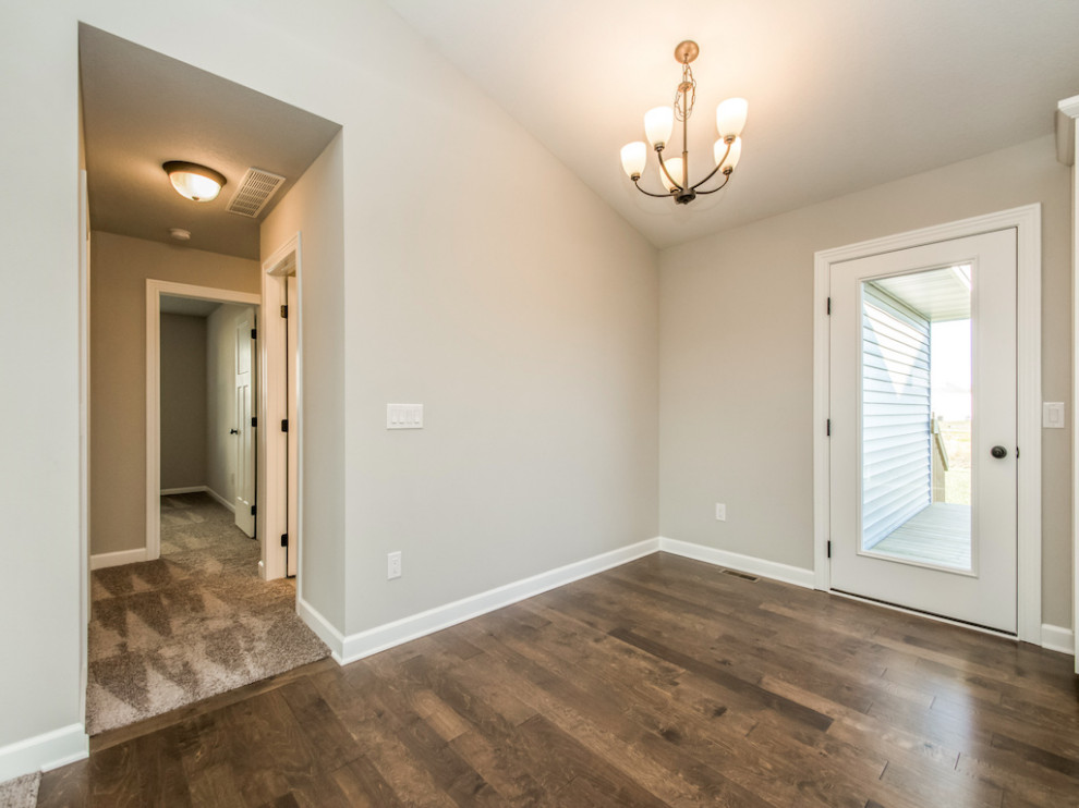 Example of a small transitional medium tone wood floor and brown floor kitchen/dining room combo design with beige walls