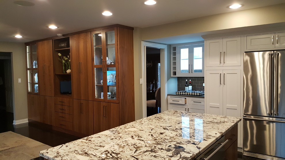 Photo of a large transitional eat-in kitchen in Chicago with an undermount sink, shaker cabinets, white cabinets, quartzite benchtops, brown splashback, glass tile splashback, stainless steel appliances, dark hardwood floors and with island.