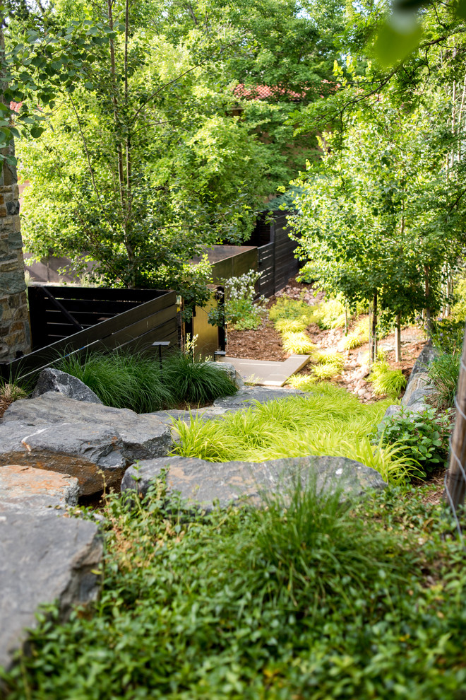 Inspiration for an expansive contemporary sloped partial sun xeriscape for summer in Denver with a garden path and natural stone pavers.