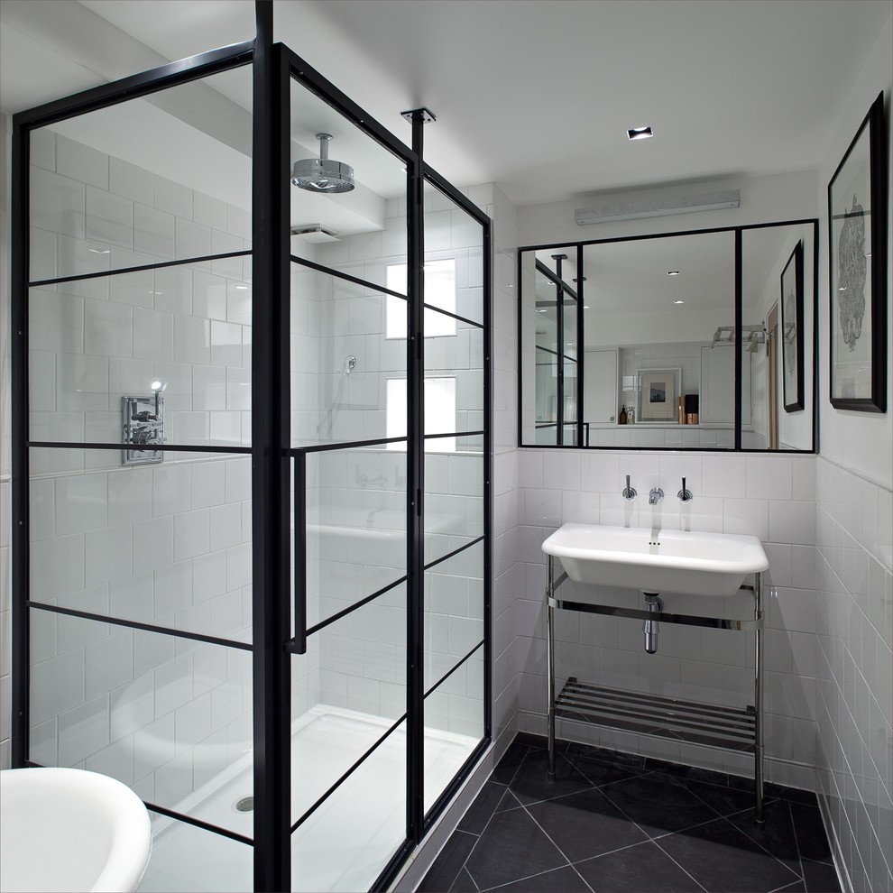 Contemporary bathroom in London with a console sink, a corner shower, white tile, ceramic tile, white walls and black floor.