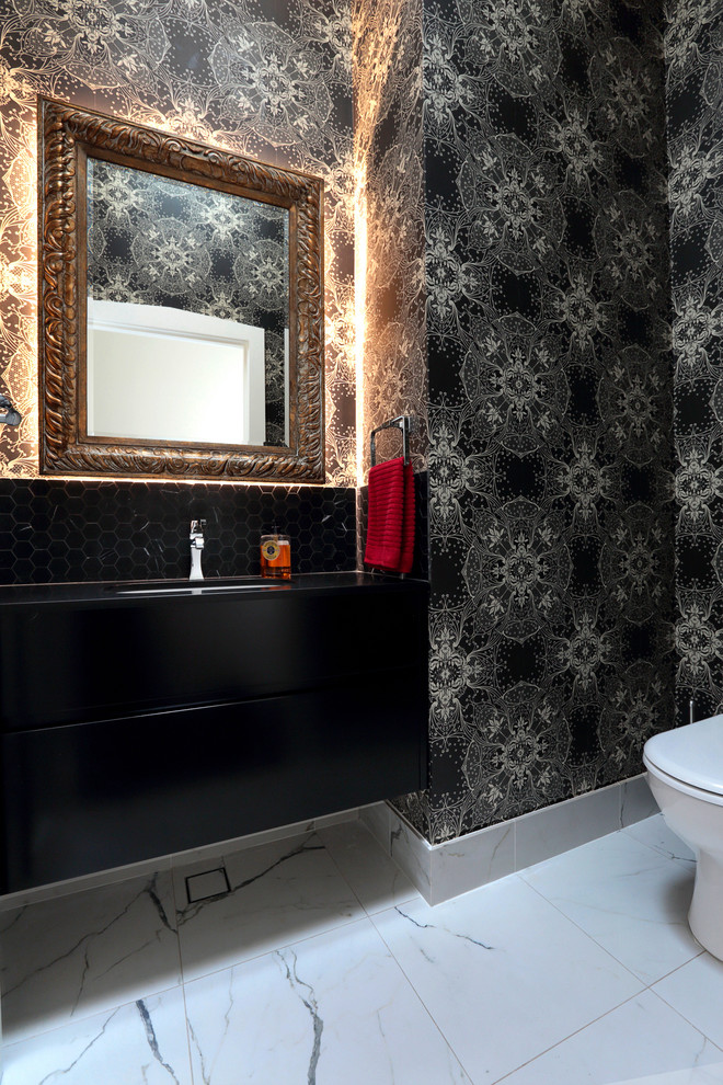This is an example of a small transitional powder room in Sydney with an undermount sink, flat-panel cabinets, black cabinets, engineered quartz benchtops, a one-piece toilet, black tile, white tile, black walls and porcelain floors.