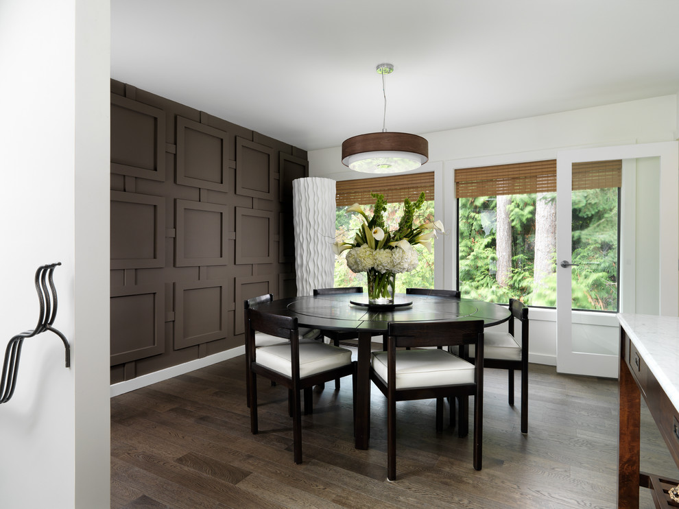 This is an example of a contemporary dining room in Vancouver with white walls and dark hardwood floors.