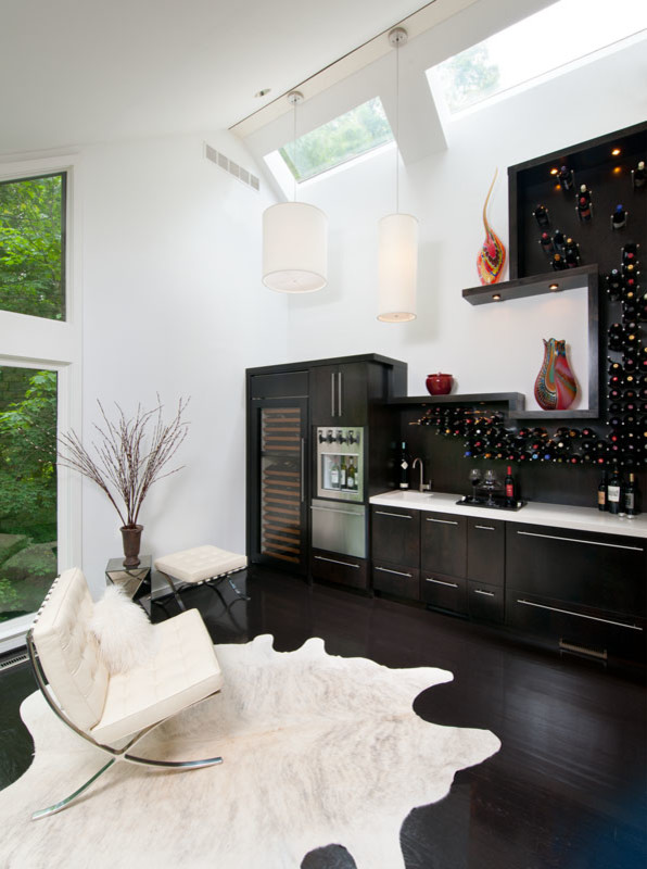 Photo of a contemporary wine cellar in Other with black floor.