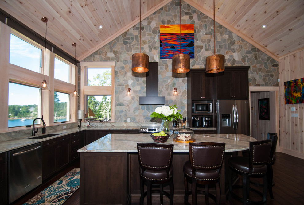 Inspiration for a large transitional l-shaped dark wood floor and brown floor eat-in kitchen remodel with an undermount sink, shaker cabinets, dark wood cabinets, granite countertops, beige backsplash, stone tile backsplash, stainless steel appliances and an island