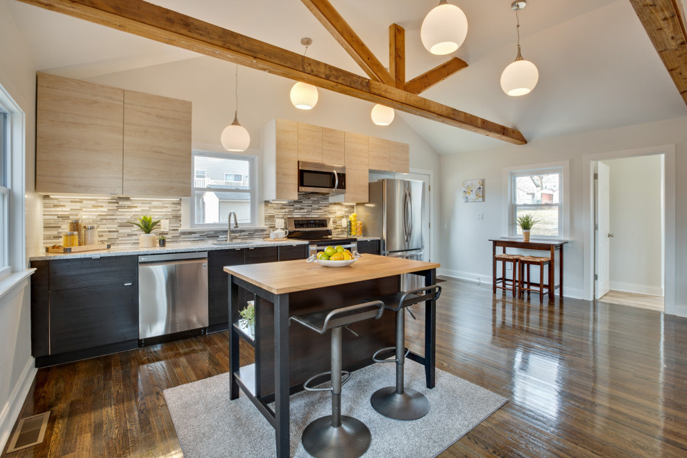 Small transitional galley dark wood floor, brown floor and exposed beam eat-in kitchen photo in Wilmington with an undermount sink, flat-panel cabinets, light wood cabinets, granite countertops, metallic backsplash, mosaic tile backsplash, stainless steel appliances, an island and multicolored countertops