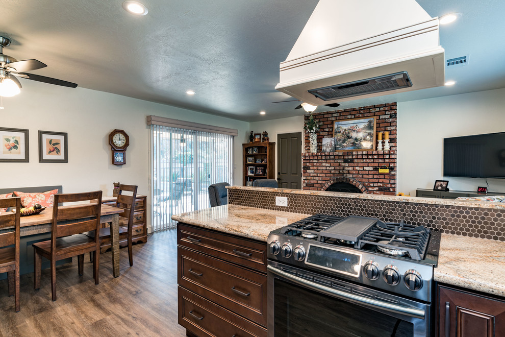 Eat-in kitchen - mid-sized transitional u-shaped medium tone wood floor and brown floor eat-in kitchen idea with an undermount sink, recessed-panel cabinets, white cabinets, granite countertops, brown backsplash, mosaic tile backsplash, stainless steel appliances and no island