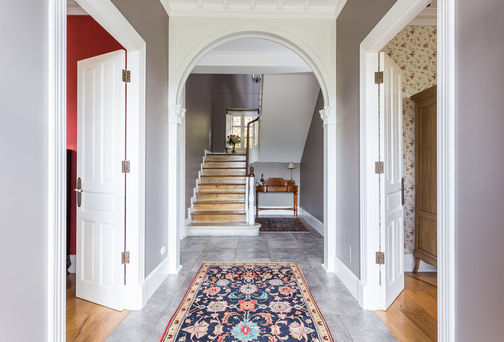 Inspiration for a mid-sized traditional entry hall in Madrid with grey walls.