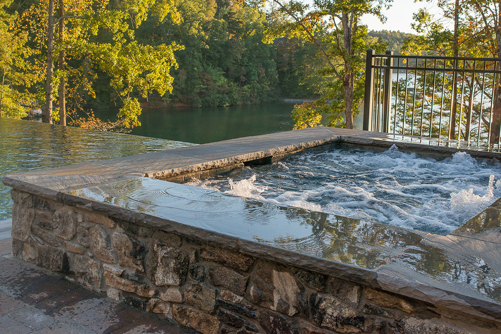 Hot tub - small rustic backyard rectangular and concrete paver infinity hot tub idea