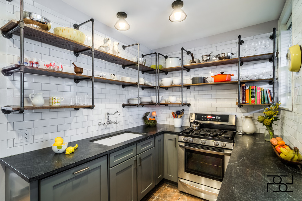 This is an example of a mid-sized transitional u-shaped separate kitchen in Chicago with an undermount sink, open cabinets, dark wood cabinets, marble benchtops, white splashback, subway tile splashback, stainless steel appliances, porcelain floors and no island.