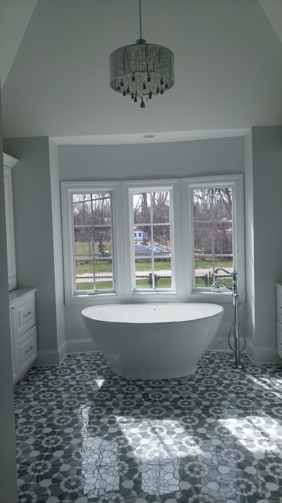 Design ideas for a large vintage bathroom in Chicago with raised-panel cabinets, white cabinets, a freestanding bath, a built-in shower, a two-piece toilet, white tiles, ceramic tiles, blue walls, marble flooring, a submerged sink, marble worktops, blue floors, a hinged door and white worktops.