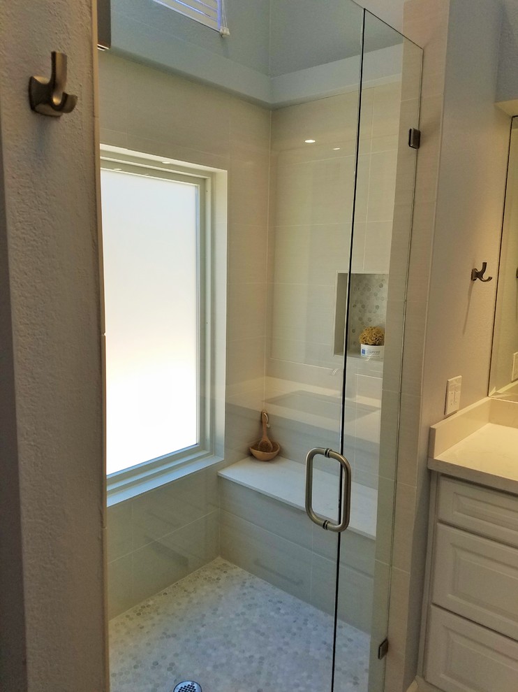 Inspiration for a mid-sized contemporary master bathroom in Minneapolis with raised-panel cabinets, white cabinets, a curbless shower, a one-piece toilet, ceramic floors, an undermount sink, engineered quartz benchtops, grey floor and a hinged shower door.