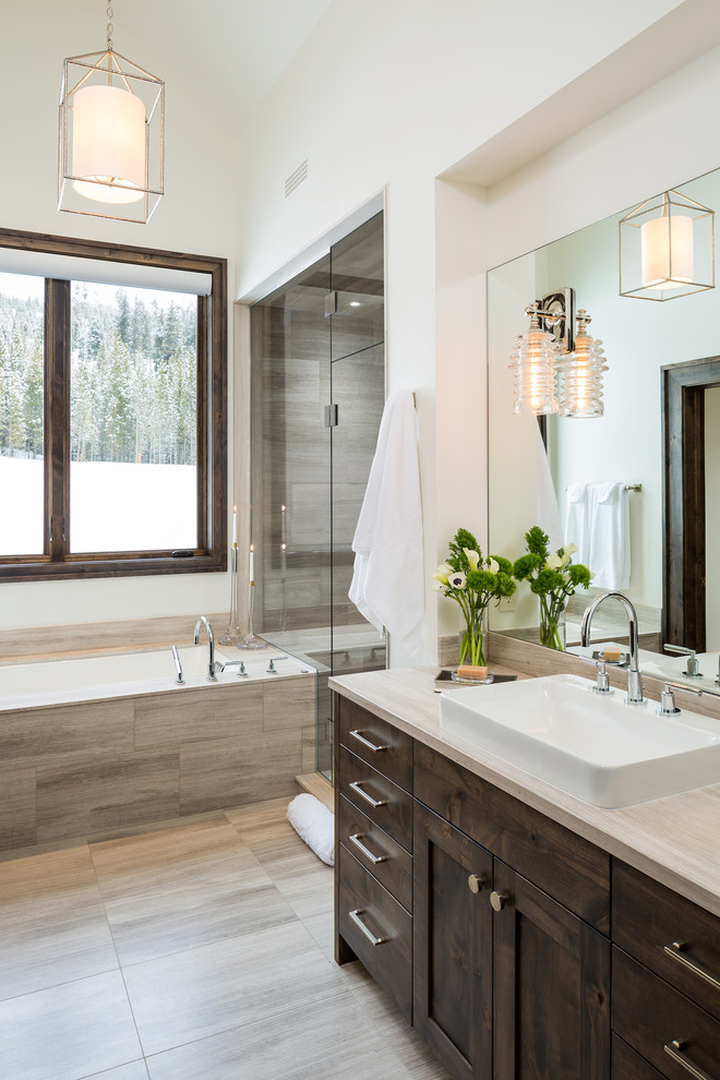 Transitional master bathroom in Other with shaker cabinets, dark wood cabinets, an undermount tub, an alcove shower, gray tile, white walls and a vessel sink.