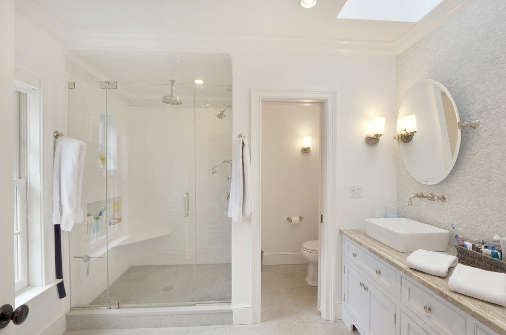 Large traditional master bathroom in New York with a vessel sink, flat-panel cabinets, white cabinets, an alcove shower, a two-piece toilet, beige tile, ceramic tile, white walls and ceramic floors.