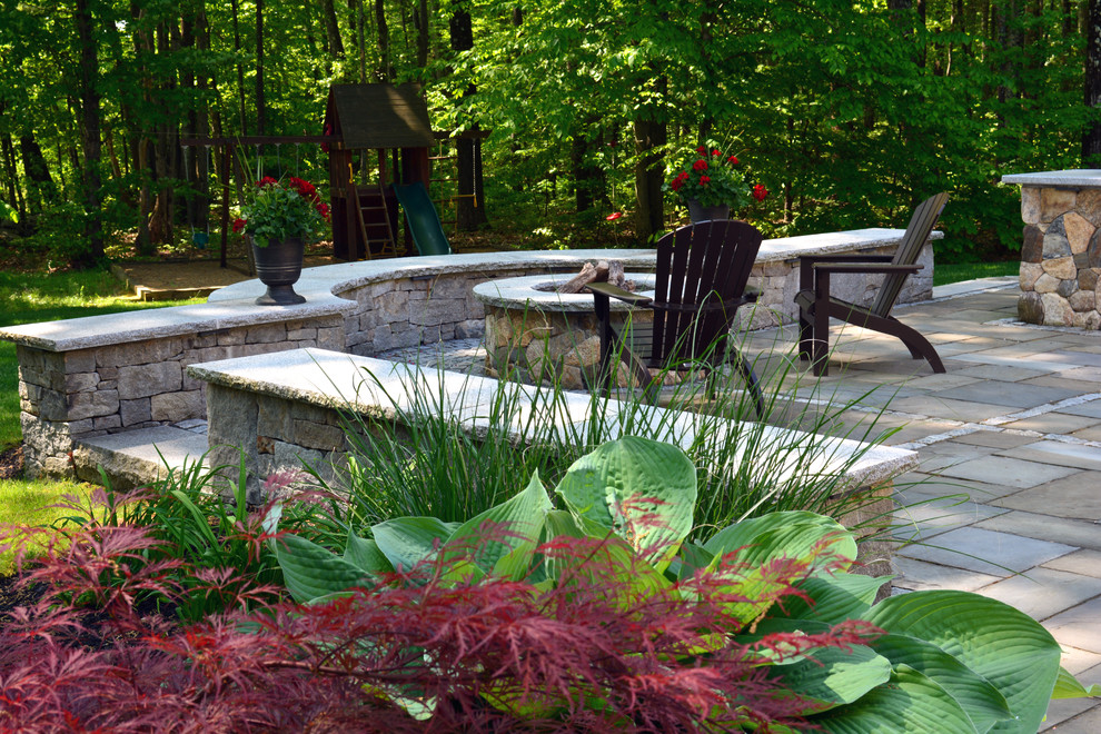 Design ideas for a country backyard patio in Boston with a fire feature and natural stone pavers.