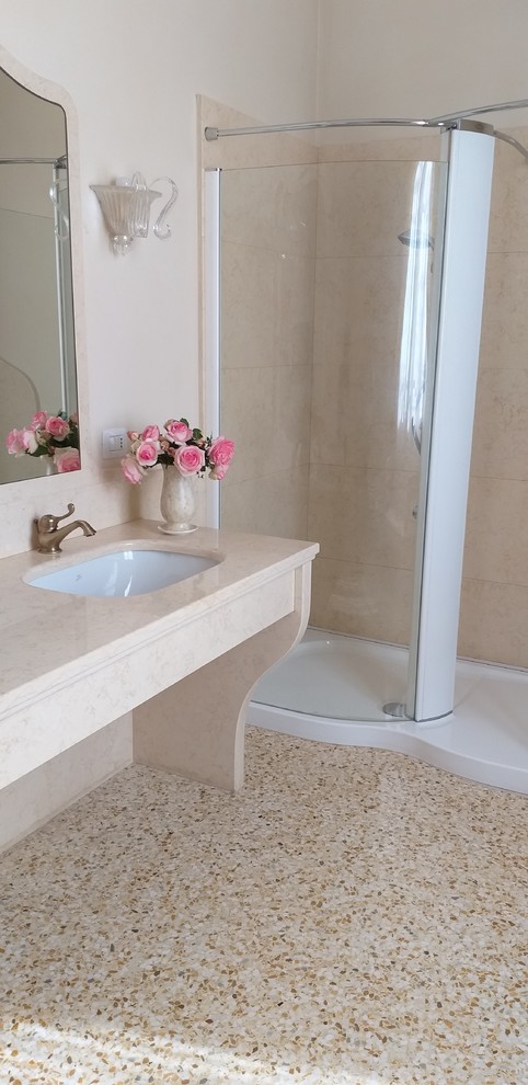 Design ideas for a large traditional bathroom in Milan with a corner tub, an alcove shower, a wall-mount toilet, yellow tile, marble, yellow walls, an undermount sink, marble benchtops, yellow floor, a hinged shower door and yellow benchtops.
