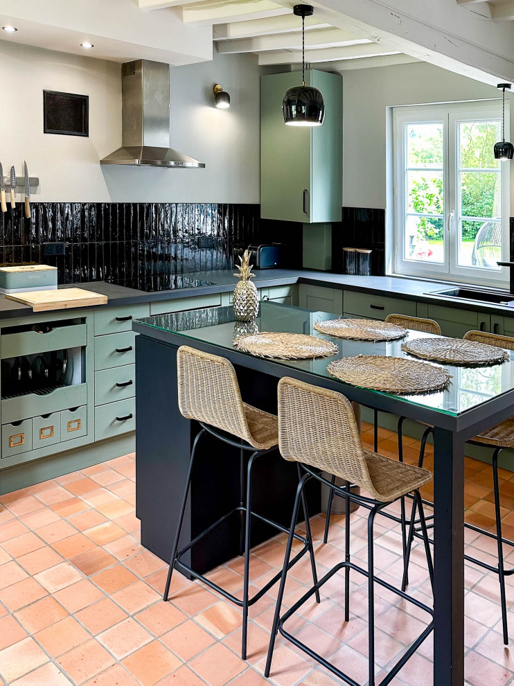 Photo of a large traditional l-shaped eat-in kitchen in Other with a single-bowl sink, laminate benchtops, black splashback, ceramic splashback, black appliances, terra-cotta floors, with island, orange floor and grey benchtop.