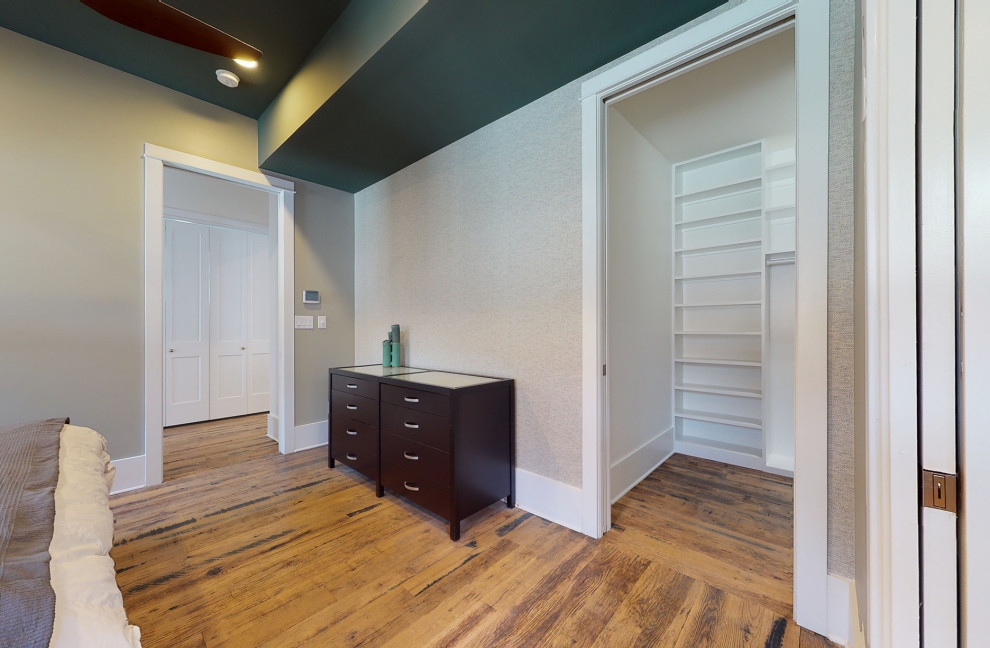 Inspiration for a modern master medium tone wood floor bedroom remodel in Louisville with green walls