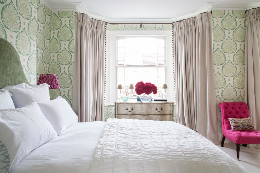 Photo of a mid-sized eclectic guest bedroom in London with green walls and carpet.