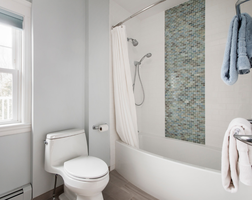 Photo of a mid-sized traditional 3/4 bathroom in Boston with recessed-panel cabinets, white cabinets, an alcove tub, a shower/bathtub combo, a one-piece toilet, multi-coloured tile, mosaic tile, white walls, porcelain floors, an undermount sink, quartzite benchtops, beige floor and a shower curtain.
