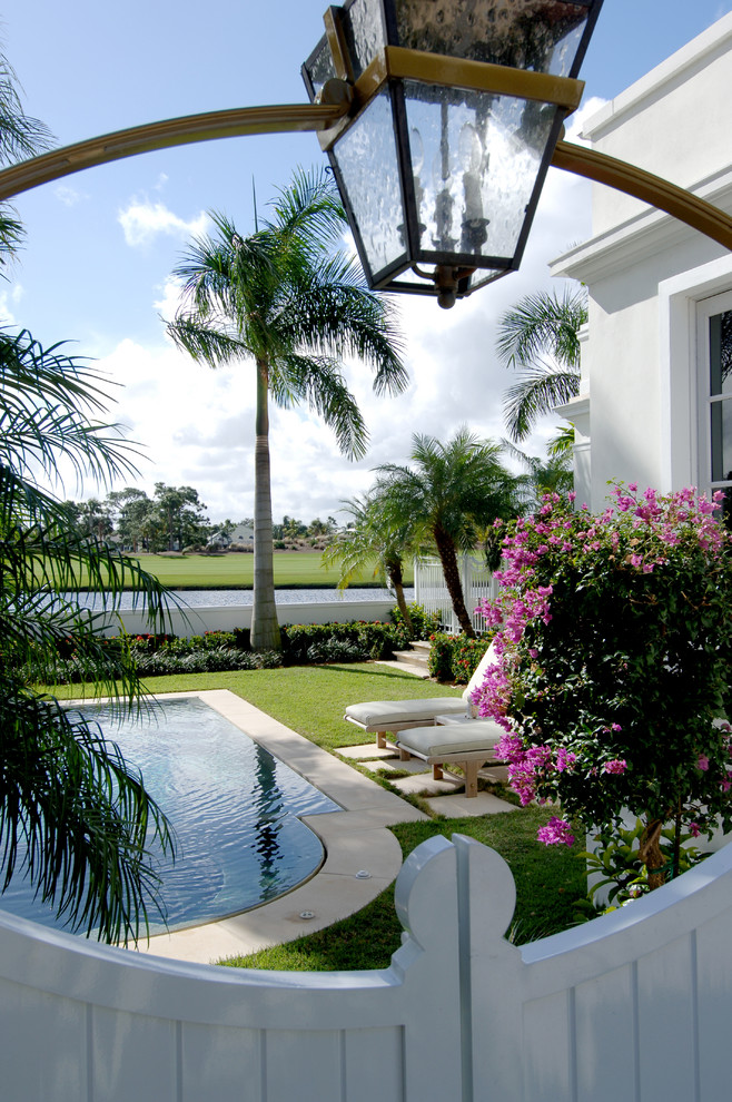 Photo of a tropical side yard pool in Miami.