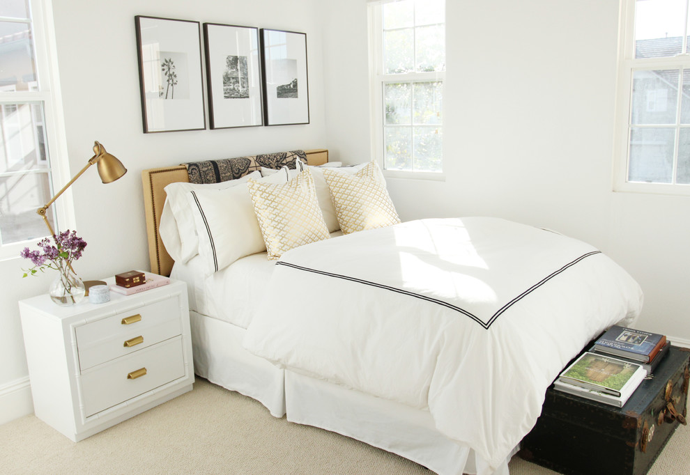 Inspiration for a transitional bedroom in Orange County with white walls and carpet.
